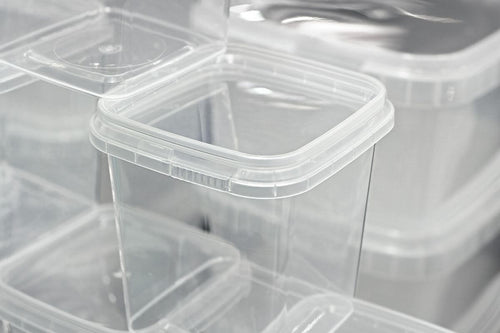 Clear plastic food containers stacked together for commercial food storage and packaging